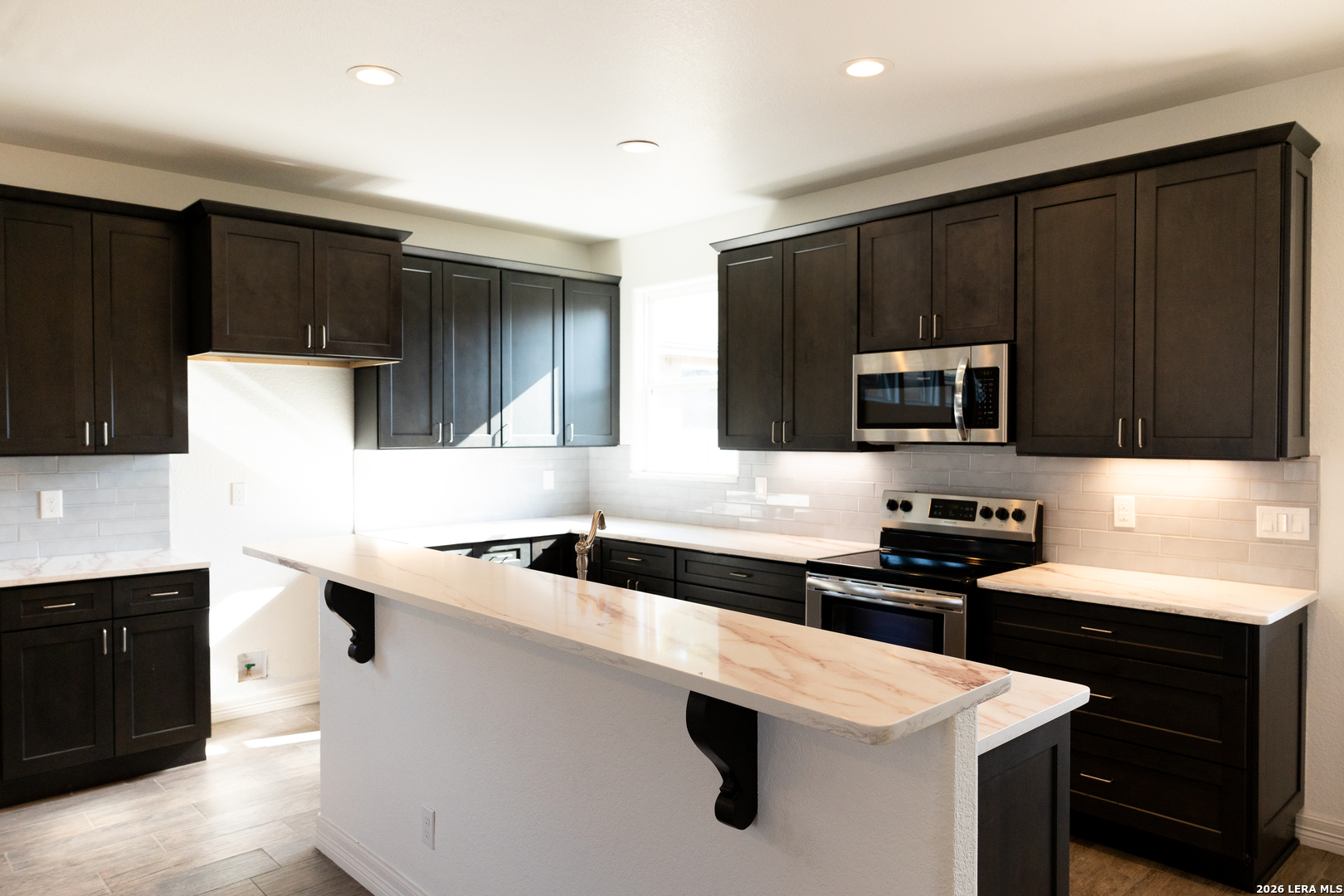 20 Rio Seco Uvalde, TX 78801 - Photo 5 of 21 a kitchen with a sink dishwasher a stove and a refrigerator