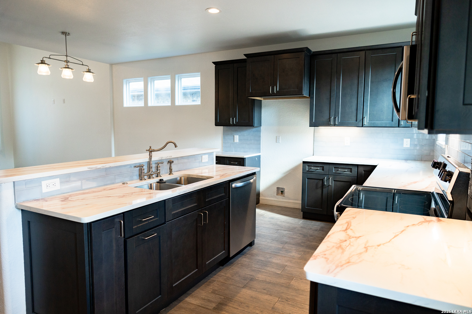 20 Rio Seco Uvalde, TX 78801 - Photo 6 of 21 a kitchen with a sink a stove and cabinets