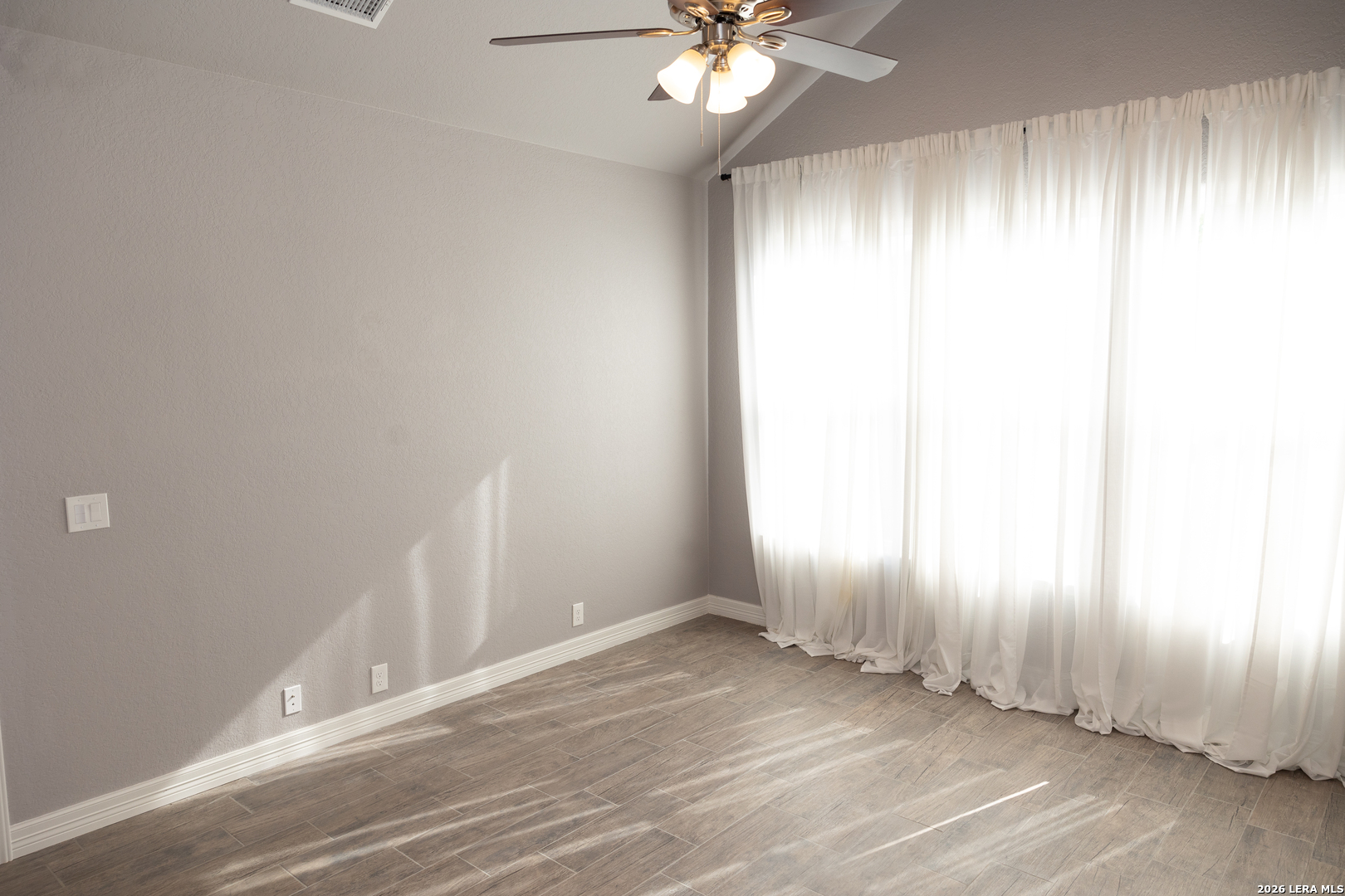 20 Rio Seco Uvalde, TX 78801 - Photo 7 of 21 an empty room with wooden floor and windows in it