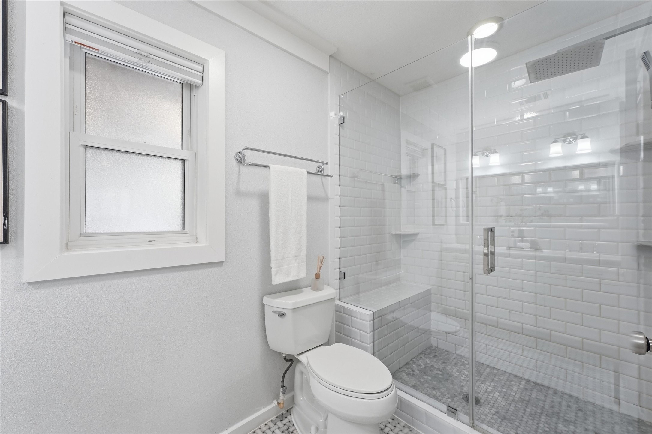 4701 Hummingbird Street Houston, TX 77035 - Photo 16 of 28 The primary bathroom features a frameless glass shower with marble hexagon tile flooring and a built-in shower seat.