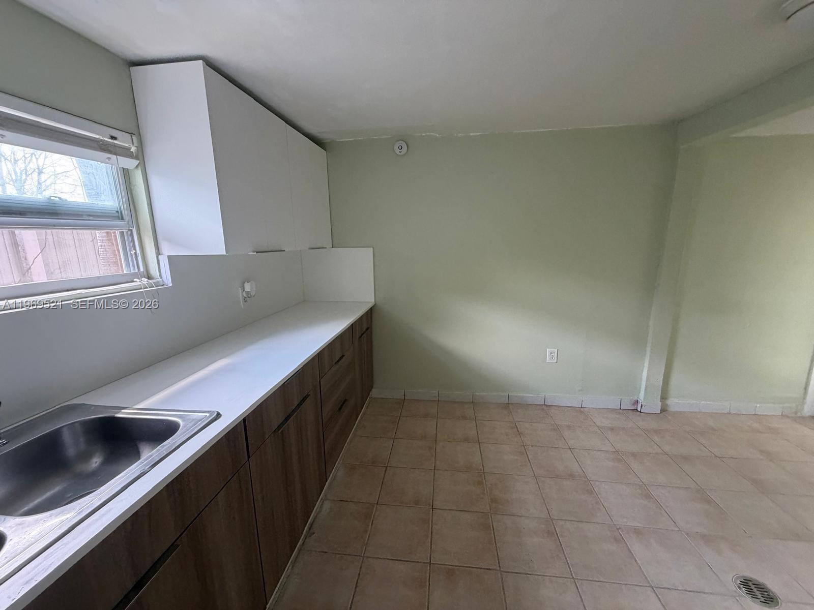 9770 Southwest 47th Street, Unit 2 Miami, FL 33165 - Photo 4 of 9 a kitchen with a sink and cabinets