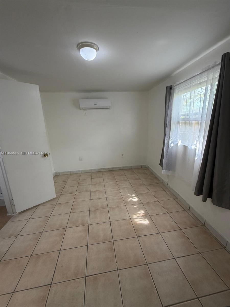 9770 Southwest 47th Street, Unit 2 Miami, FL 33165 - Photo 5 of 9 a view of an empty room and window