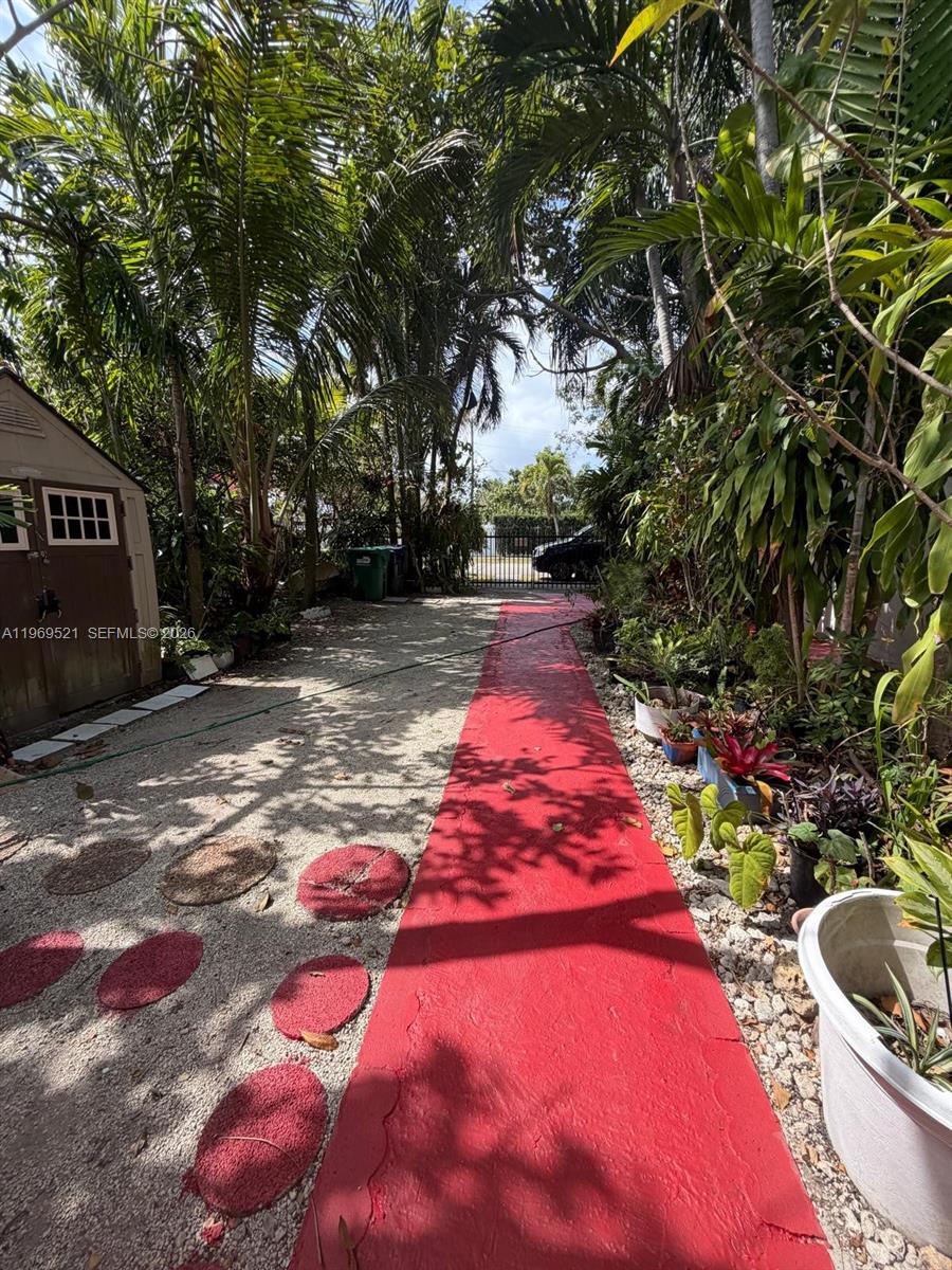 9770 Southwest 47th Street, Unit 2 Miami, FL 33165 - Photo 9 of 9 a backyard of a house with yard and outdoor seating
