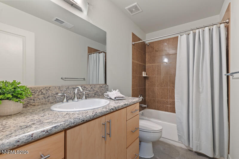 374 State Street Reno, NV 89501 - Photo 13 of 16 a bathroom with a granite countertop sink a toilet and shower