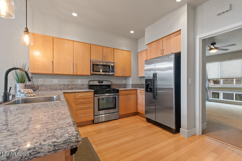 374 State Street Reno, NV 89501 - Photo 3 of 16 a kitchen with stainless steel appliances granite countertop a refrigerator and a sink