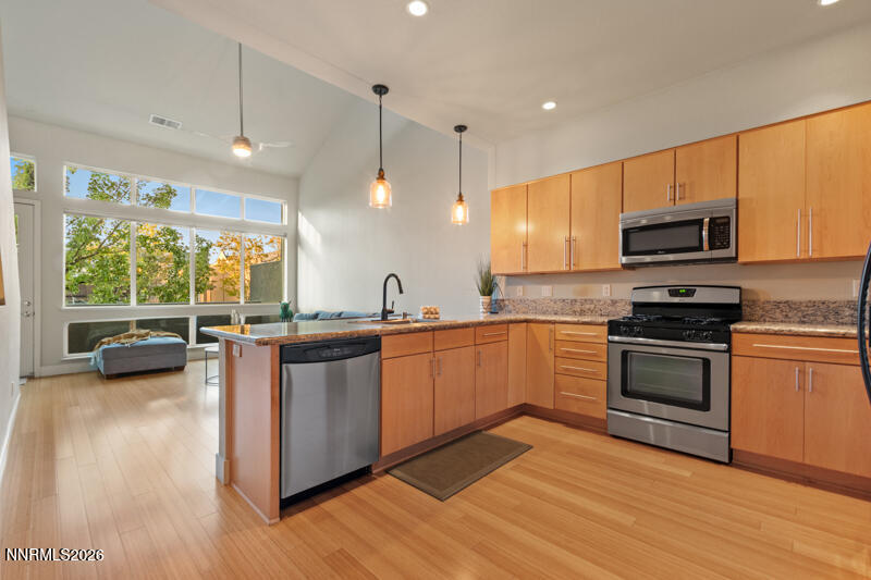 374 State Street Reno, NV 89501 - Photo 7 of 16 a kitchen with stainless steel appliances granite countertop a stove a sink and a microwave