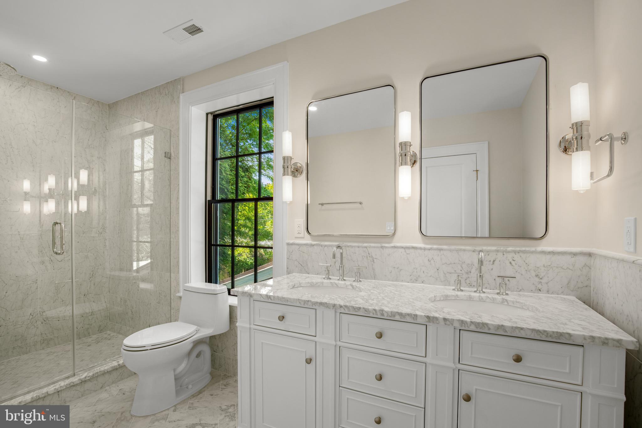 2710 36th Street Northwest Washington, DC 20007 - Photo 19 of 29 a bathroom with a granite countertop toilet a sink a mirror a window and shower