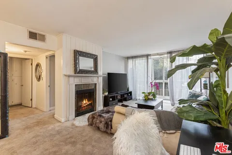 a living room with furniture and a painting