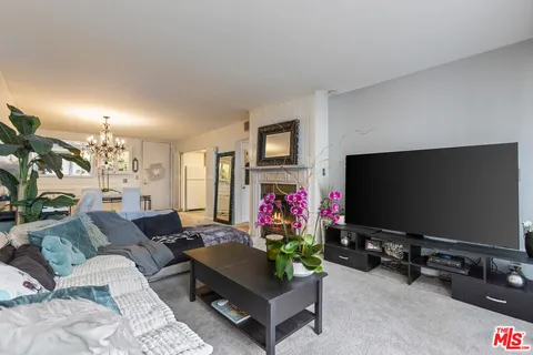 a view of a porch with a floor to ceiling window and wooden fence