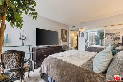 a bathroom with a double vanity sink toilet mirror and shower