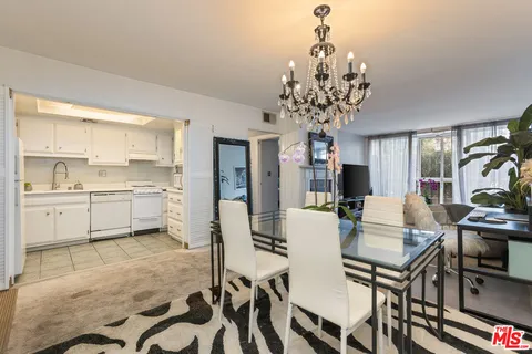 a view of a dining room with furniture and a chandelier