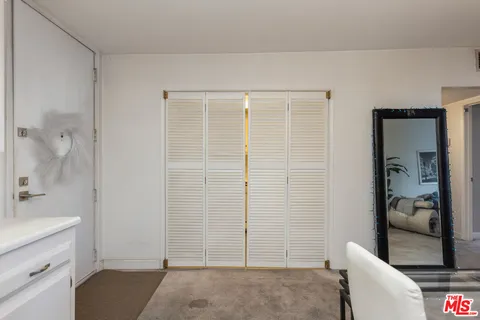 a kitchen with cabinets appliances a sink and a potted plant