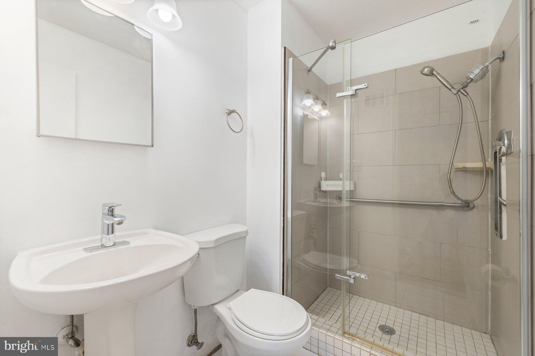 11733 Becket Street Potomac, MD 20854 - Photo 15 of 27 a bathroom with a sink toilet and shower