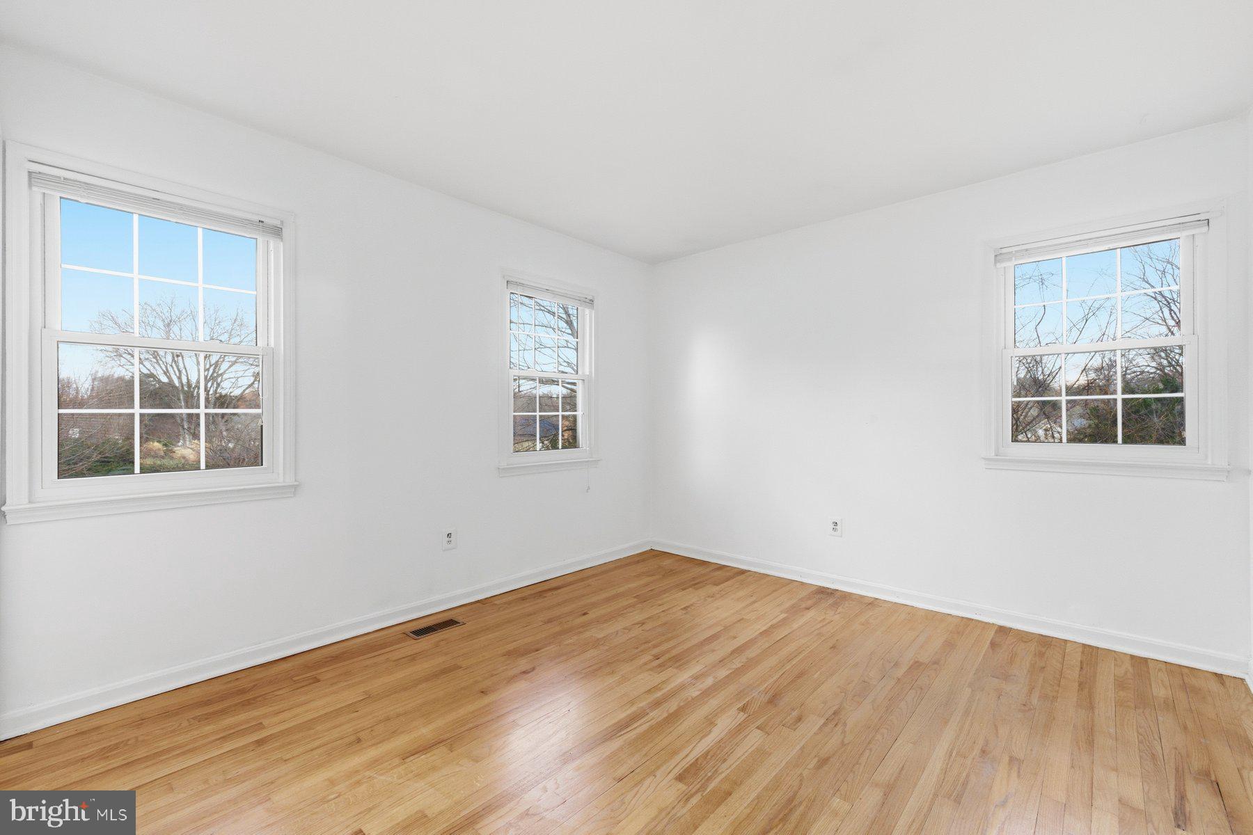 11733 Becket Street Potomac, MD 20854 - Photo 16 of 27 a view of empty room with wooden floor and fan