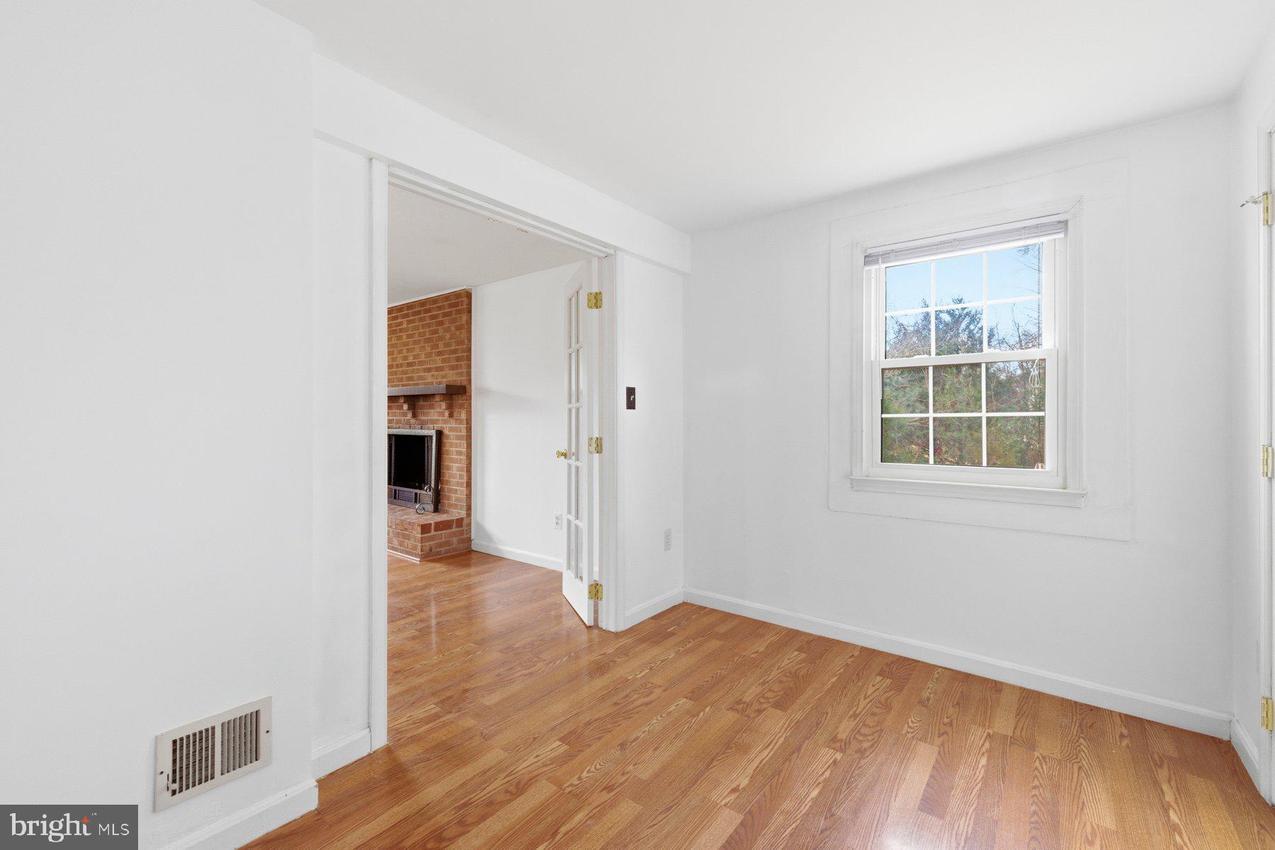 11733 Becket Street Potomac, MD 20854 - Photo 22 of 27 an empty room with wooden floor and windows