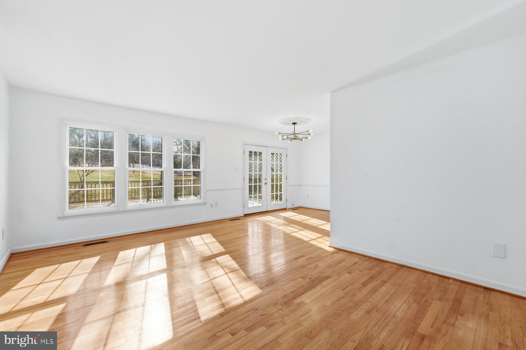 11733 Becket Street Potomac, MD 20854 - Photo 3 of 27 a view of an empty room with wooden floor and a window
