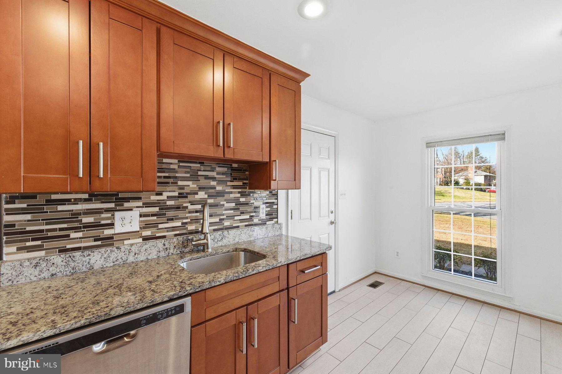 11733 Becket Street Potomac, MD 20854 - Photo 5 of 27 a kitchen with sink cabinets and window