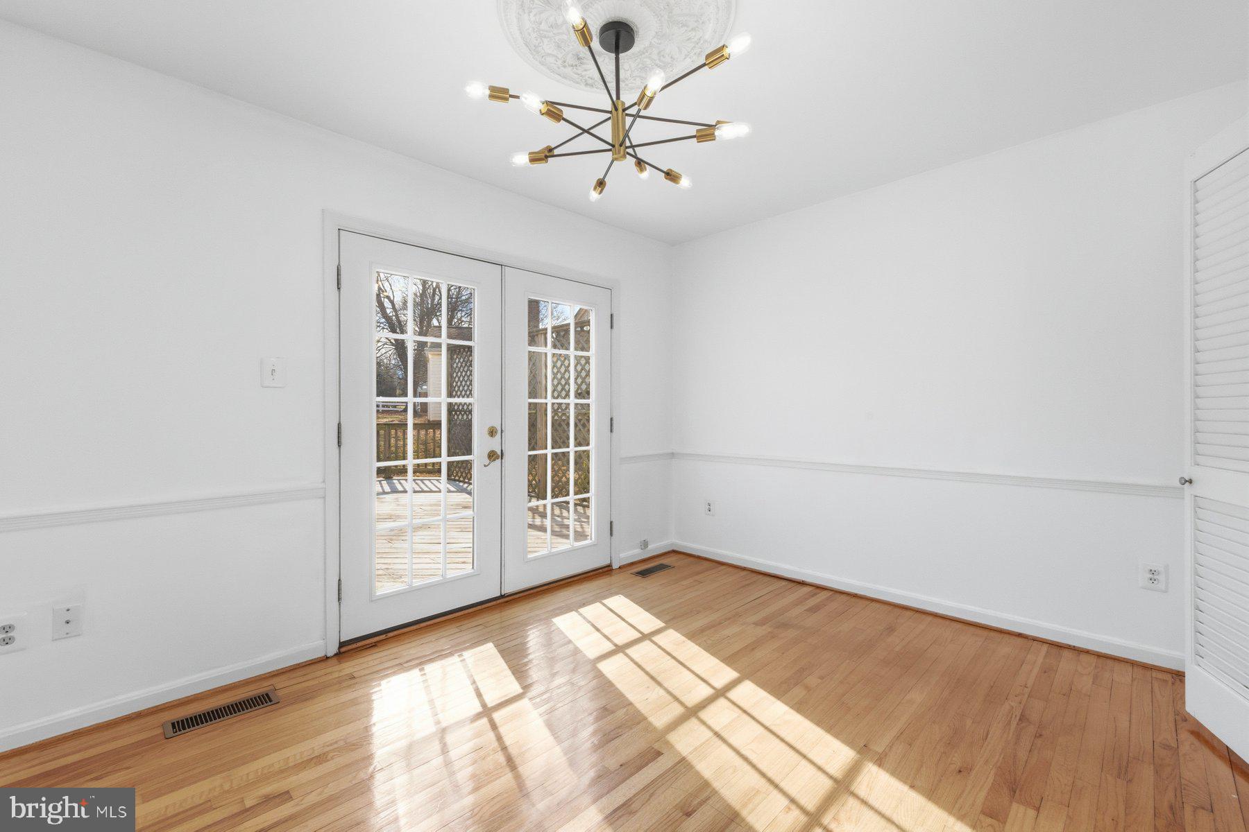 11733 Becket Street Potomac, MD 20854 - Photo 9 of 27 wooden floor in an empty room with a window