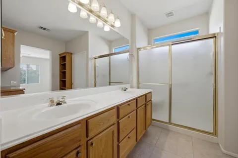 a bathroom with a sink double vanity and a mirror