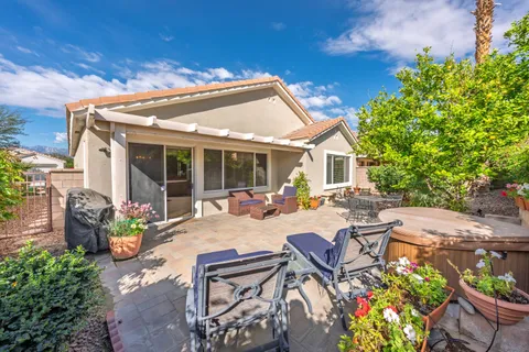 a view of a patio with table and chairs and potted plants