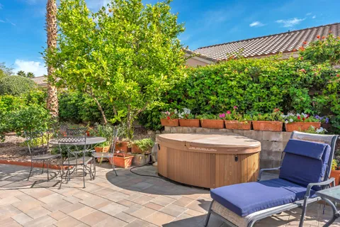 a view of a patio with table and chairs and potted plants