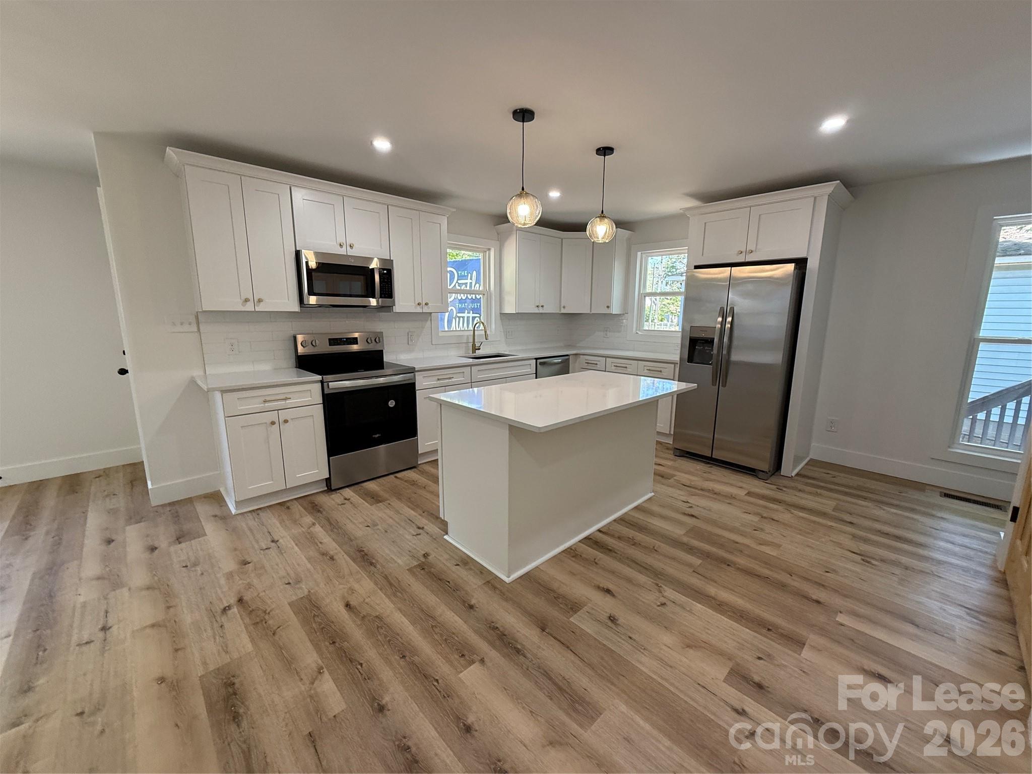 1416 North Davidson Street Charlotte, NC 28206 - Photo 2 of 15 a kitchen with a sink a counter top space stainless steel appliances and cabinets