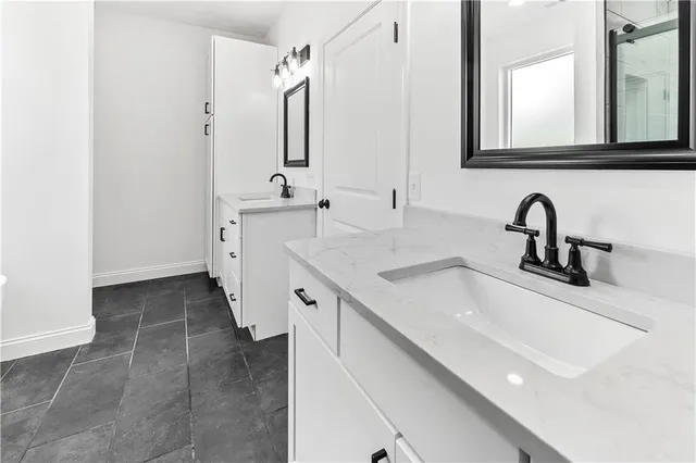 a bathroom with a double vanity sink and mirror