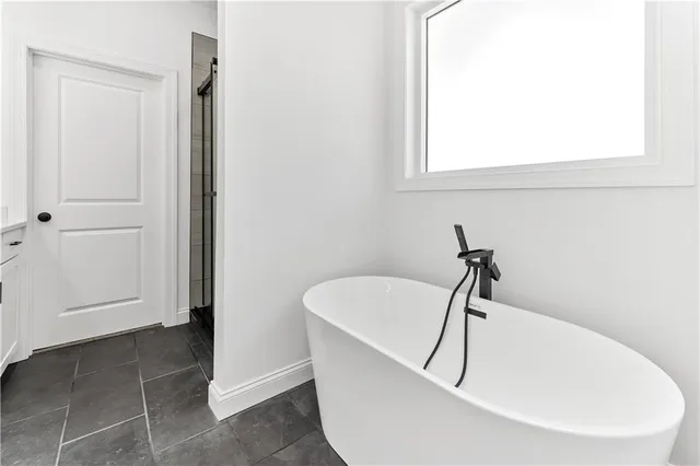 a white bath tub sitting in a bathroom