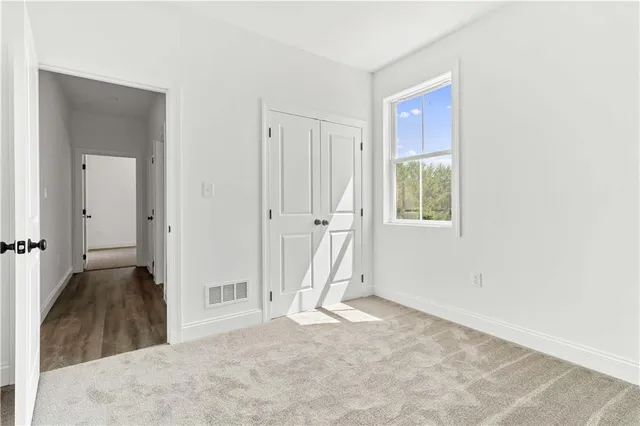 an entryway of a house and an empty room