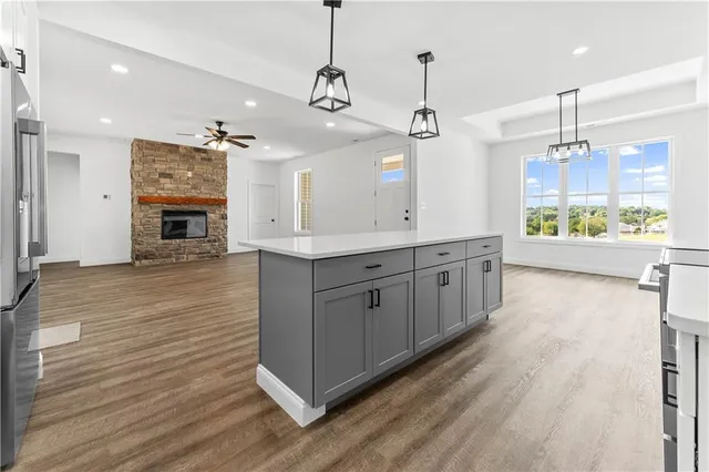 a large kitchen with stainless steel appliances granite countertop a lot of counter space