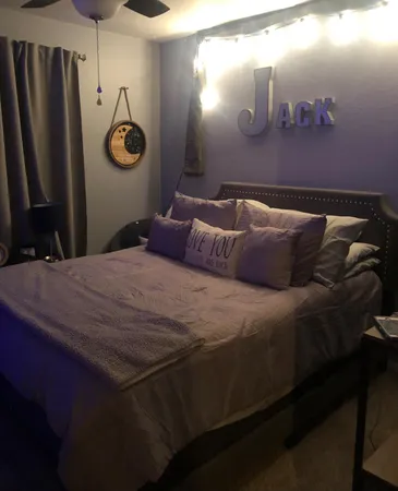 a bedroom with a bed and a table in it