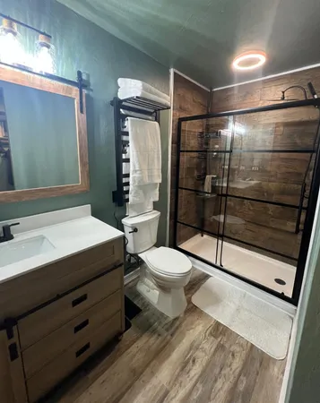 a bathroom with a toilet a sink and shower