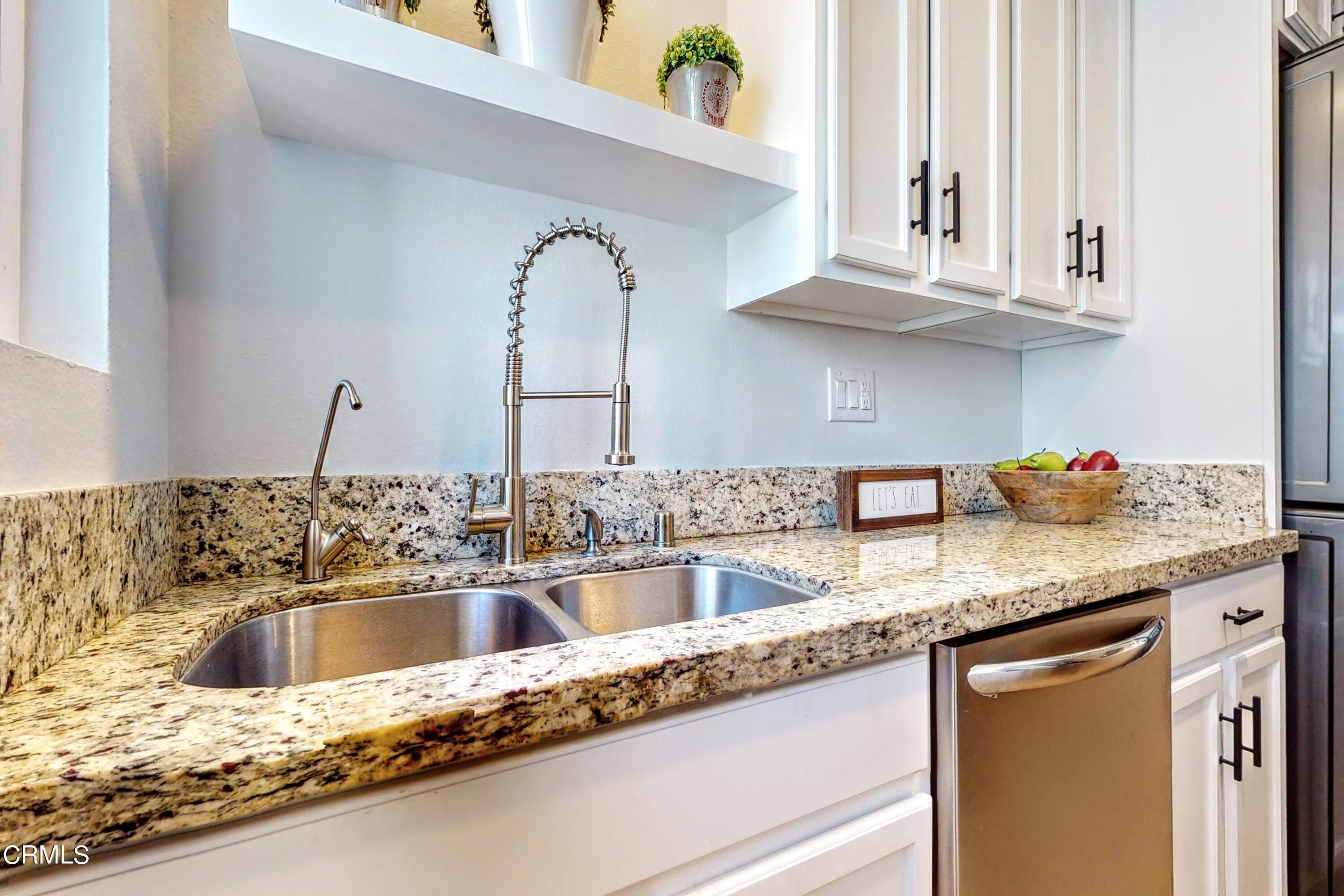 263 South Ventura Road, Unit 272 Port Hueneme, CA 93041 - Photo 12 of 40 a kitchen with granite countertop a sink a stove and cabinets