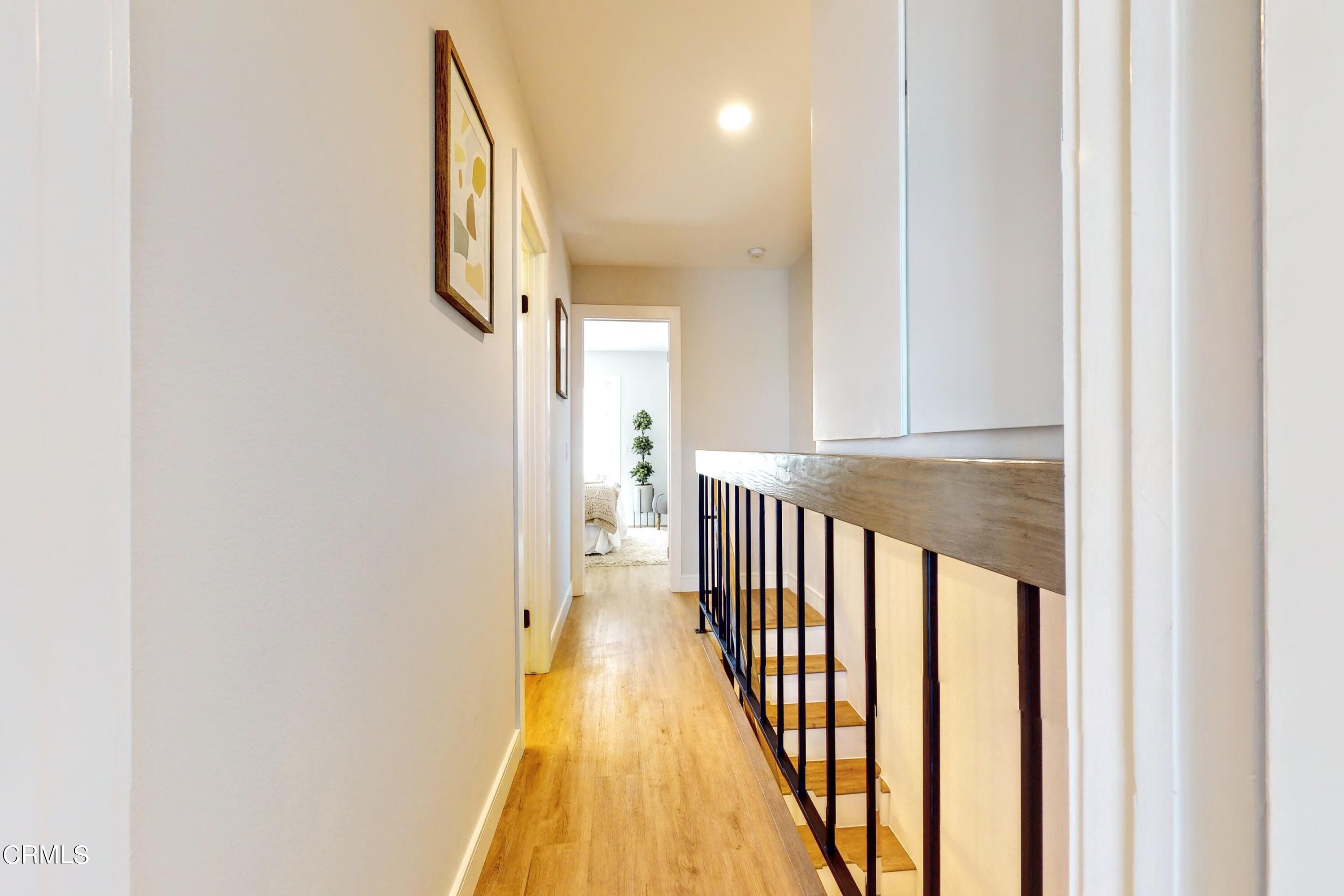 263 South Ventura Road, Unit 272 Port Hueneme, CA 93041 - Photo 30 of 40 a view of a hallway with wooden floor and staircase