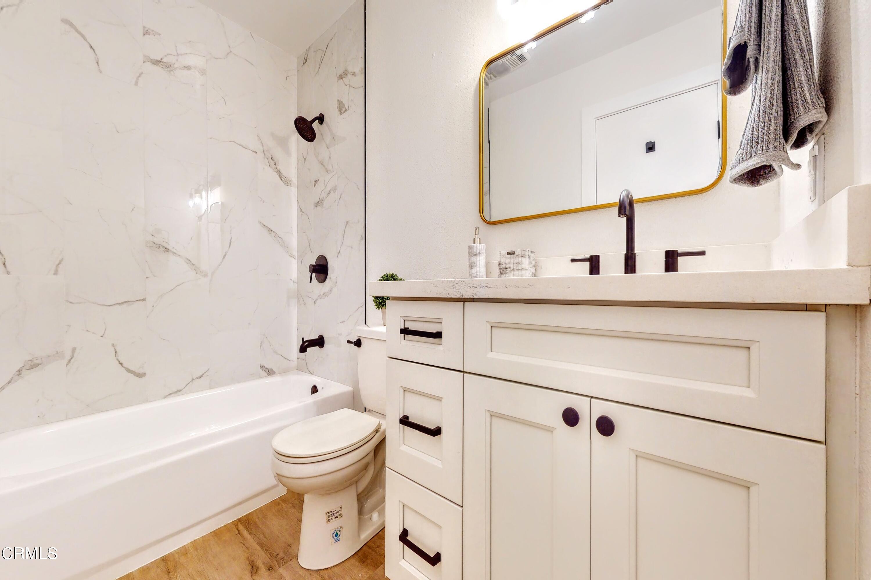 263 South Ventura Road, Unit 272 Port Hueneme, CA 93041 - Photo 32 of 40 a bathroom with a toilet sink vanity granite tub and shower