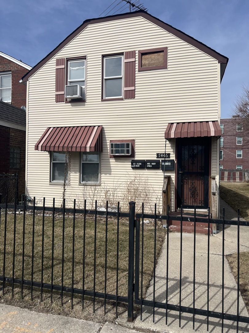 a view of a house with wooden fence