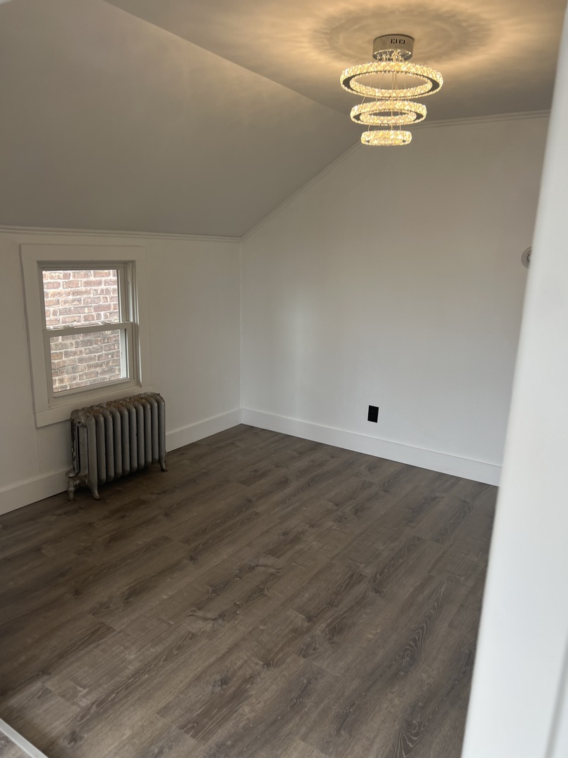 7446 64th Street, Unit 2F Summit, IL 60501 - Photo 5 of 14 an empty room with wooden floor and window