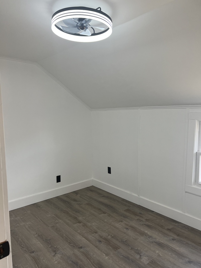 7446 64th Street, Unit 2F Summit, IL 60501 - Photo 6 of 14 an empty room with wooden floor and windows