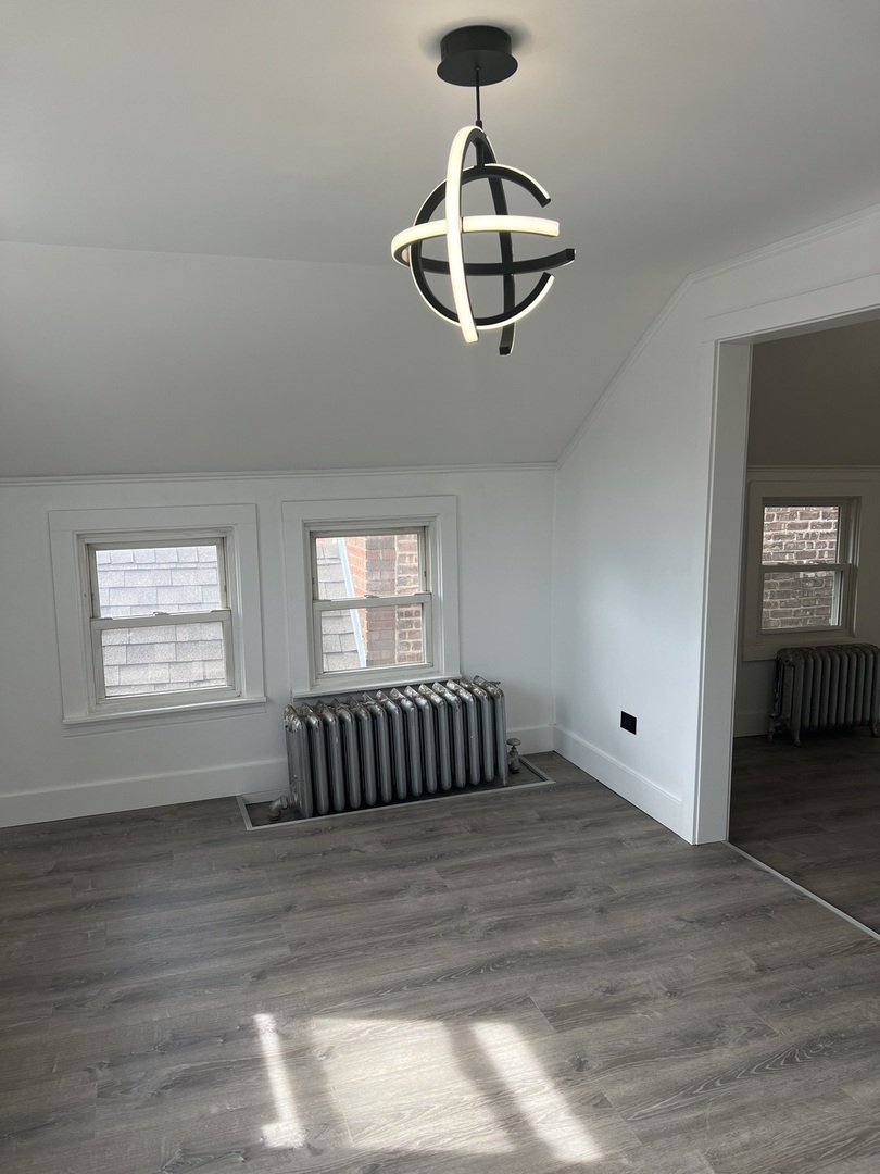 7446 64th Street, Unit 2F Summit, IL 60501 - Photo 8 of 14 a view of room with hardwood flooring and ceiling fan