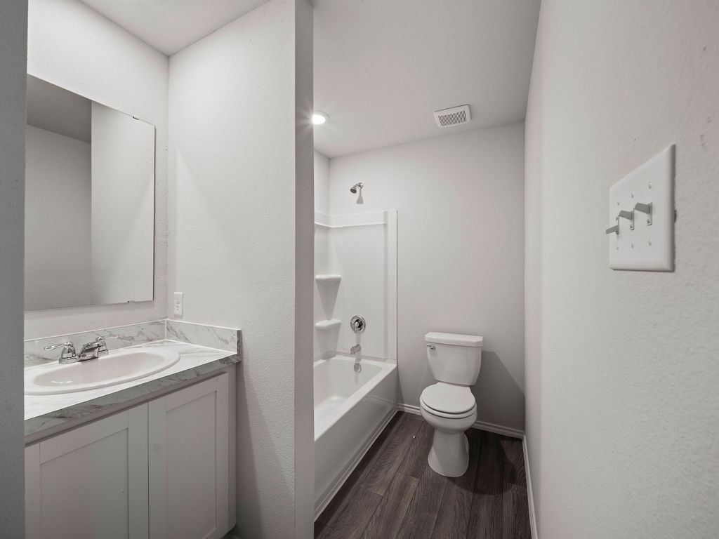 216 Stoney Ridge Lufkin, TX 75904 - Photo 11 of 21 a bathroom with a granite countertop toilet a sink and a large mirror