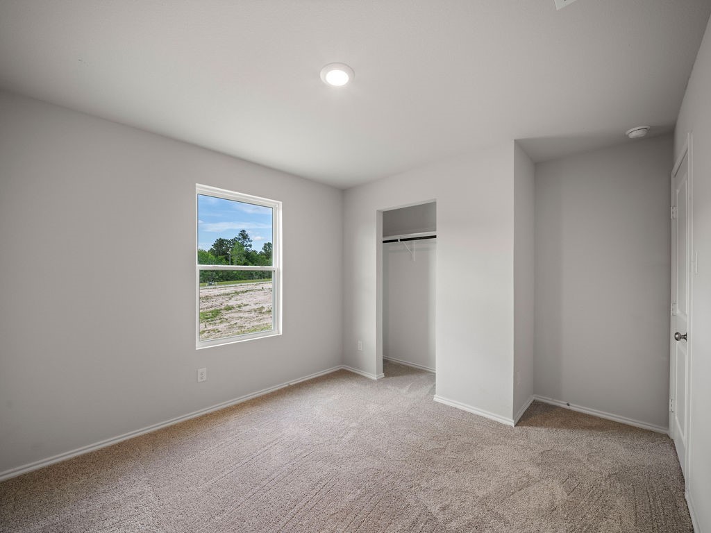 216 Stoney Ridge Lufkin, TX 75904 - Photo 20 of 21 an empty room with windows and closet