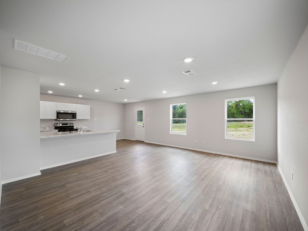 216 Stoney Ridge Lufkin, TX 75904 - Photo 3 of 21 a view of kitchen with kitchen island microwave and wooden floor
