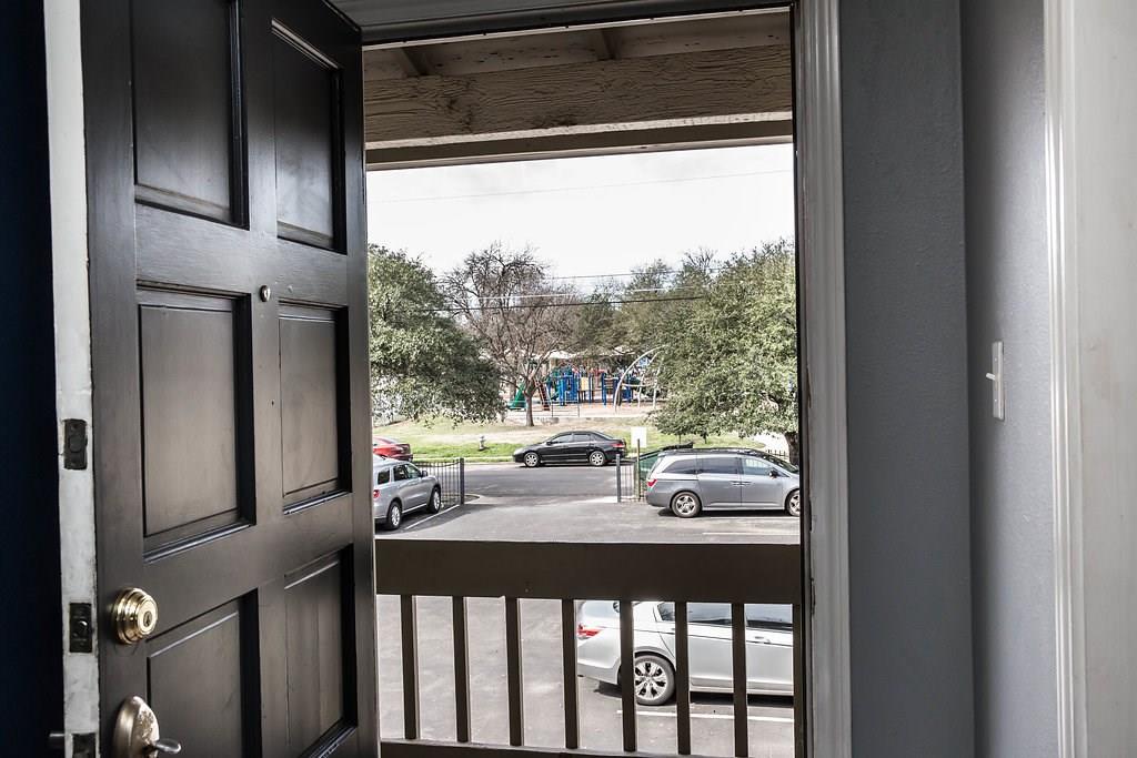 4209 Burnet Road, Unit 206 Austin, TX 78756 - Photo 2 of 20 An inviting entryway frames views of a community playground and convenient parking.