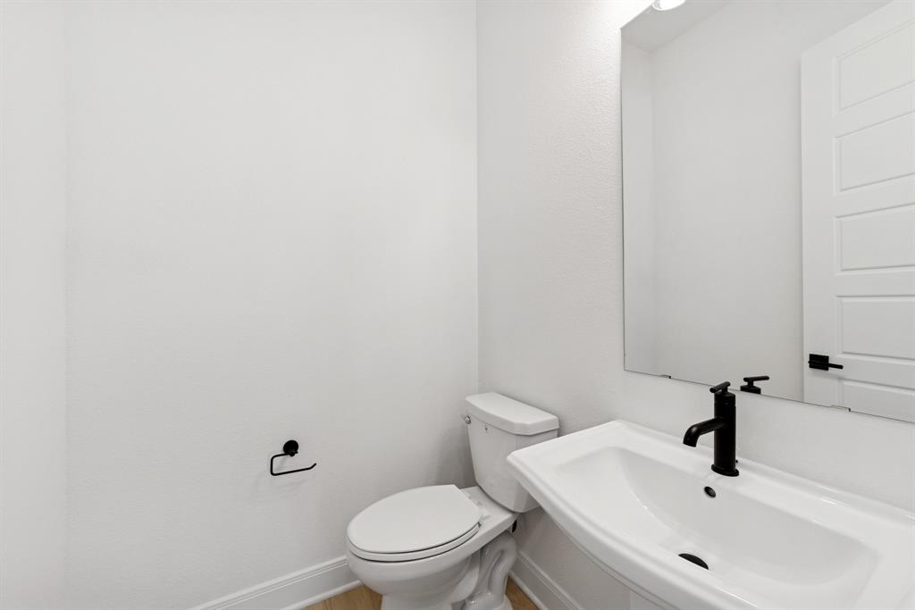 1842 Cole Road Van Alstyne, TX 75495 - Photo 14 of 35 a white toilet sitting next to a white sink