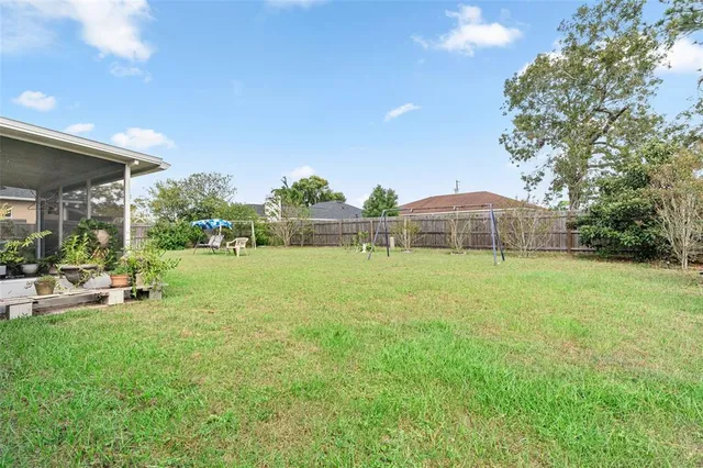 a front view of a house with garden and sitting area