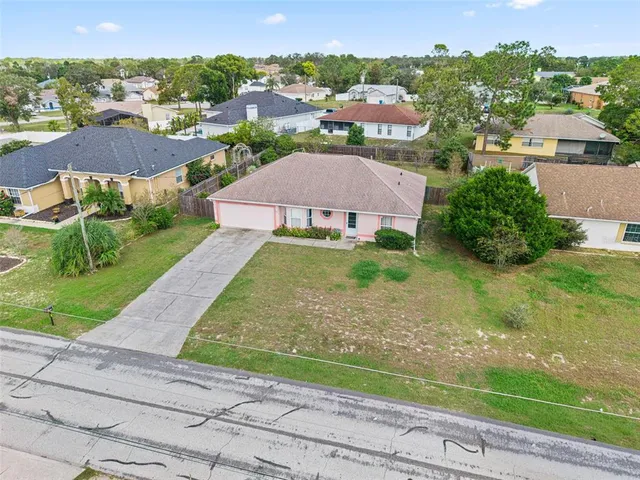 an aerial view of residential houses with outdoor space and street view
