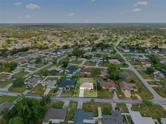 an aerial view of residential building and lake