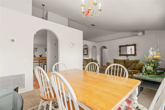 a living room with chairs and a table