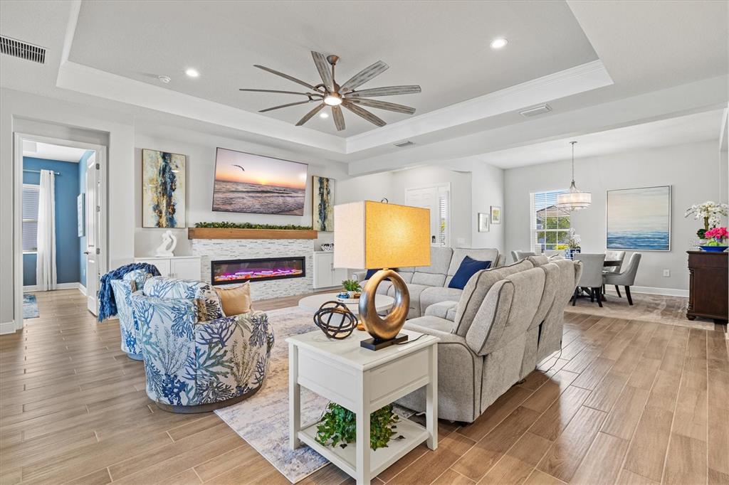 12436 Destin Loop Venice, FL 34293 - Photo 14 of 85 a living room with furniture a flat screen tv and a fireplace