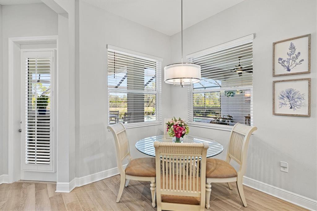 12436 Destin Loop Venice, FL 34293 - Photo 22 of 85 a view of a dining room with furniture wooden floor and chandelier